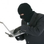Computer criminal - Hacker with laptop computer